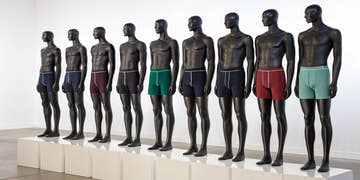 Men's square leg suits in various colors and styles displayed on mannequins.