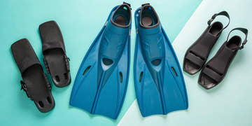 Blue long blade and black open heel swimming fins for adults.