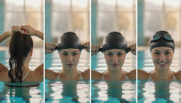 Swimmer with long hair putting on a silicone swim cap carefully
