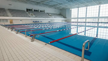 Pool lane lines dividing an indoor competitive swimming pool