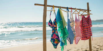A rack of colorful swim suits available to buy online.
